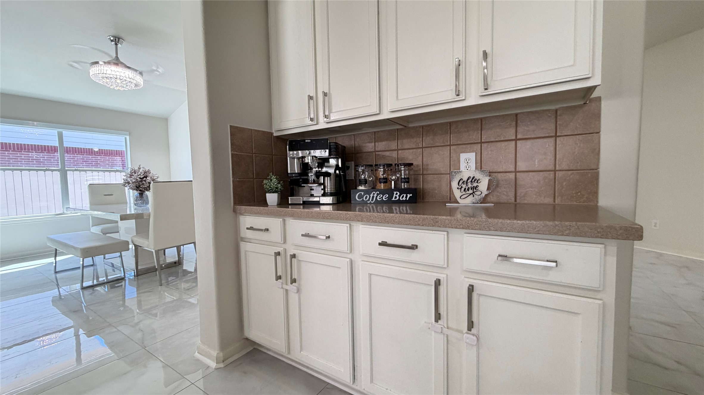 24534 Forest Path Court Spring, TX 77373 - Photo 17 of 43 a kitchen with white cabinets and a sink