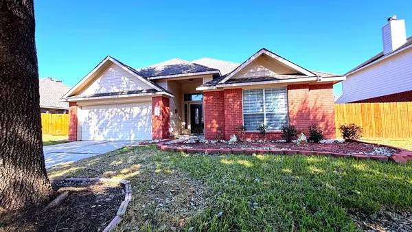a front view of a house with patio and yard