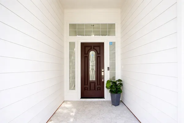 a view of a hallway with wooden floor and windows