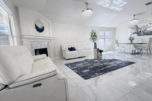 a kitchen with granite countertop a refrigerator sink and wooden cabinets