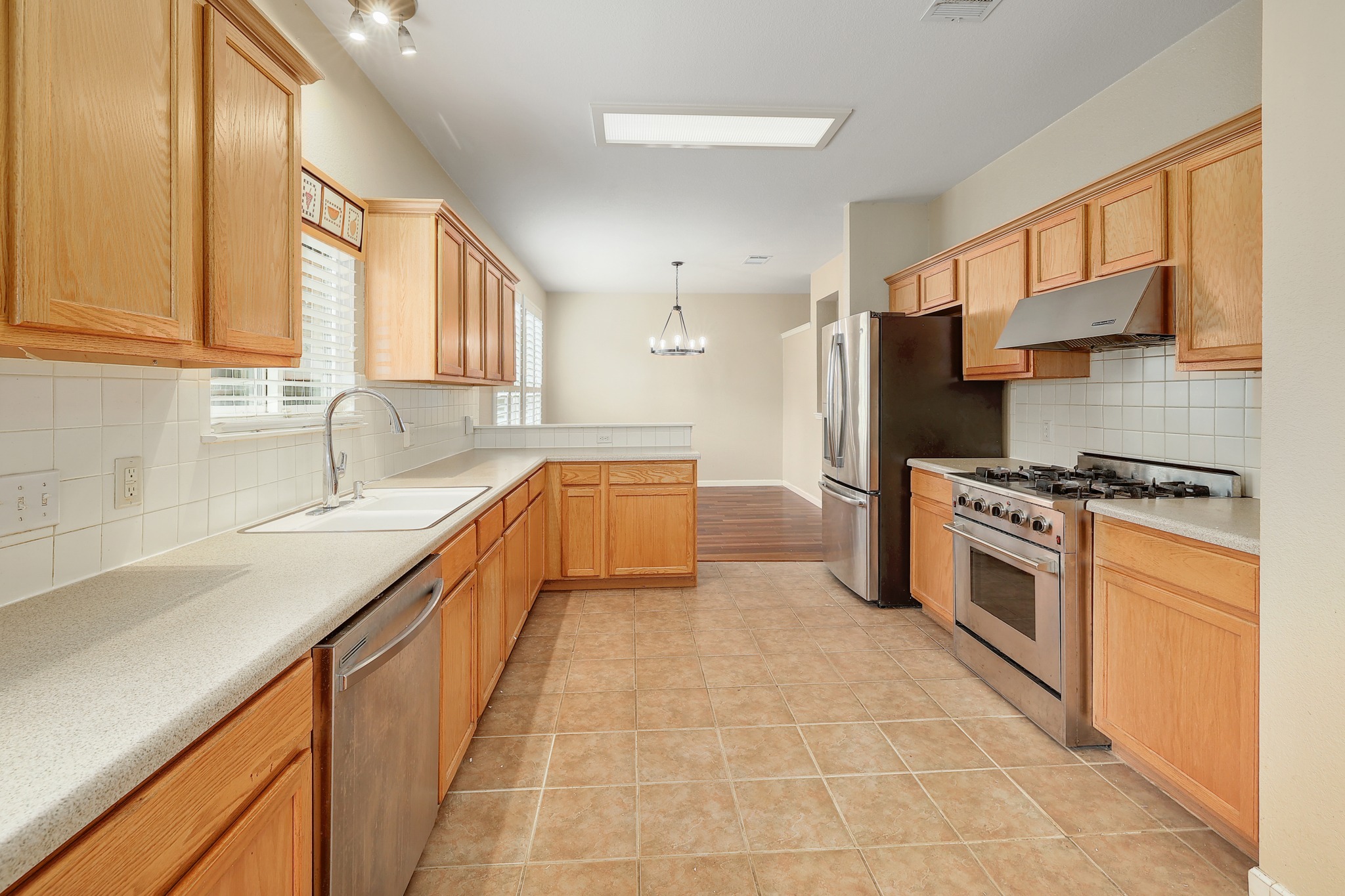 4615 Tello Path Austin, TX 78749 - Photo 10 of 31 Ample wooden cabinetry and tile flooring define this functional, open-concept cooking space.