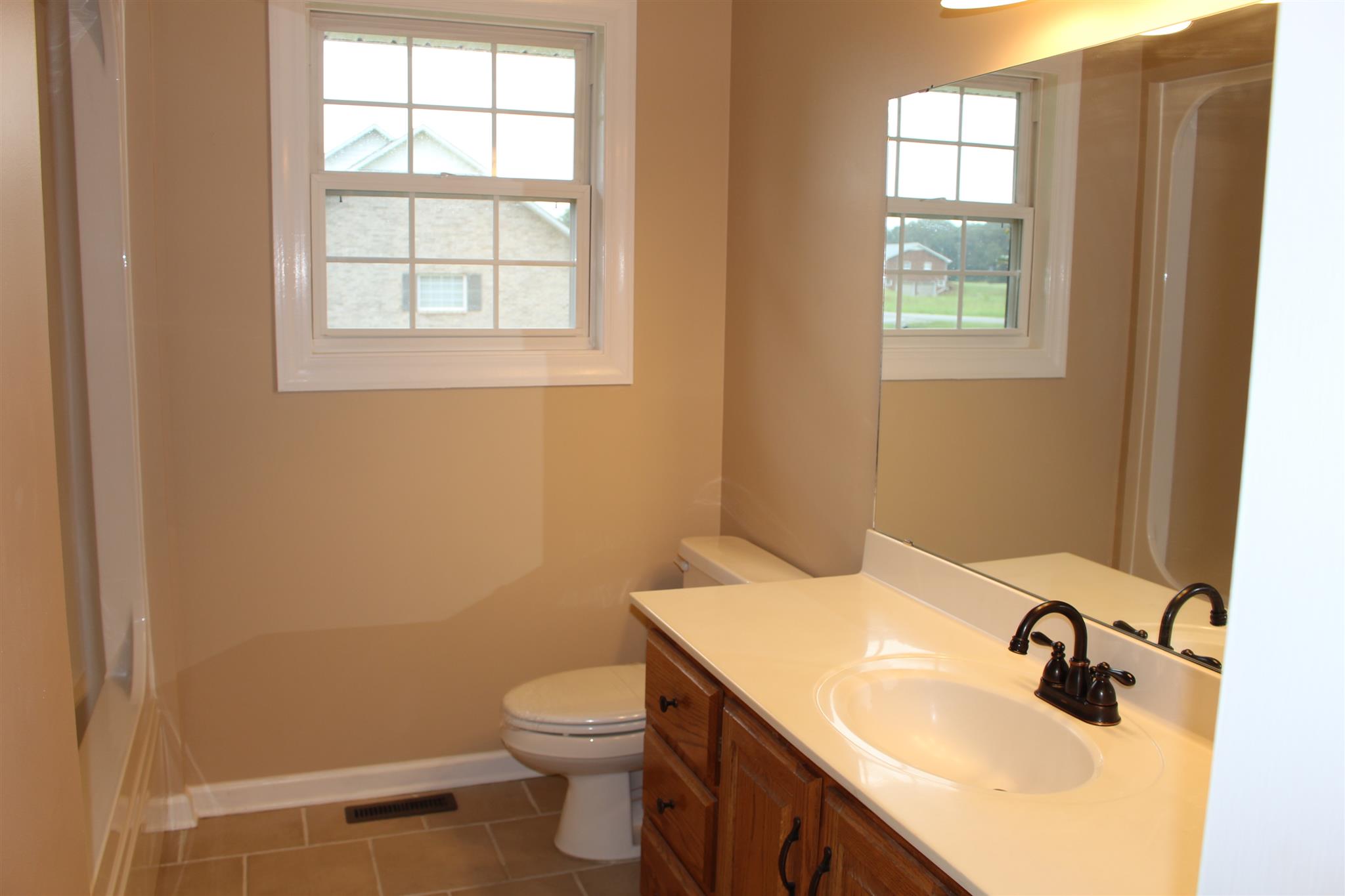 425 Brandon Road Manchester, TN 37355 - Photo 17 of 25 a bathroom with a sink toilet and window