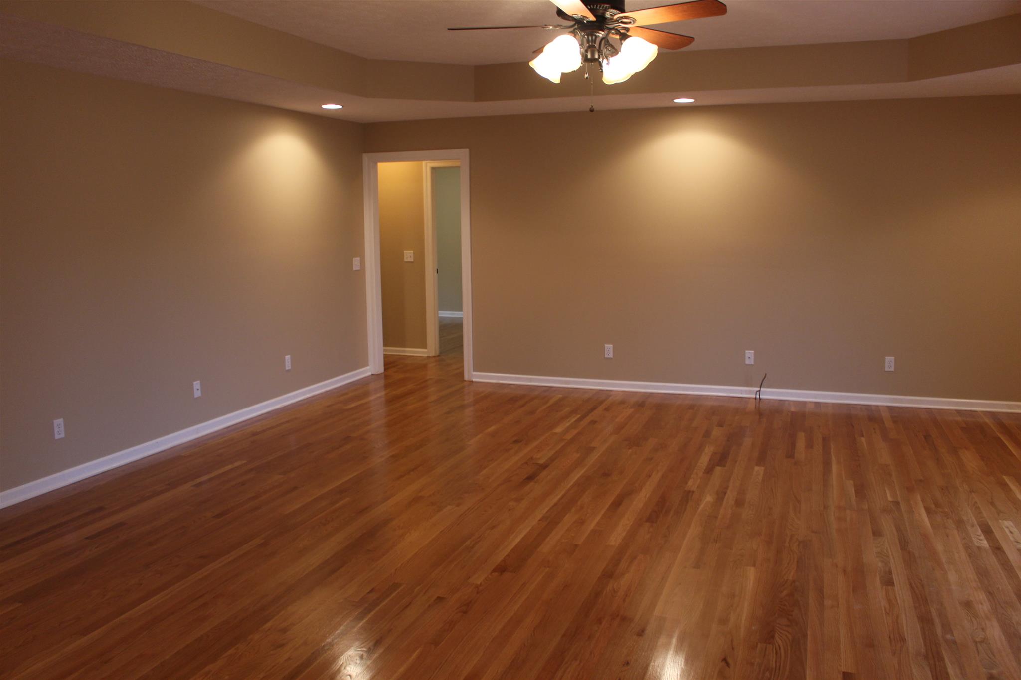 425 Brandon Road Manchester, TN 37355 - Photo 3 of 25 a view of an empty room with wooden floor and a chandelier