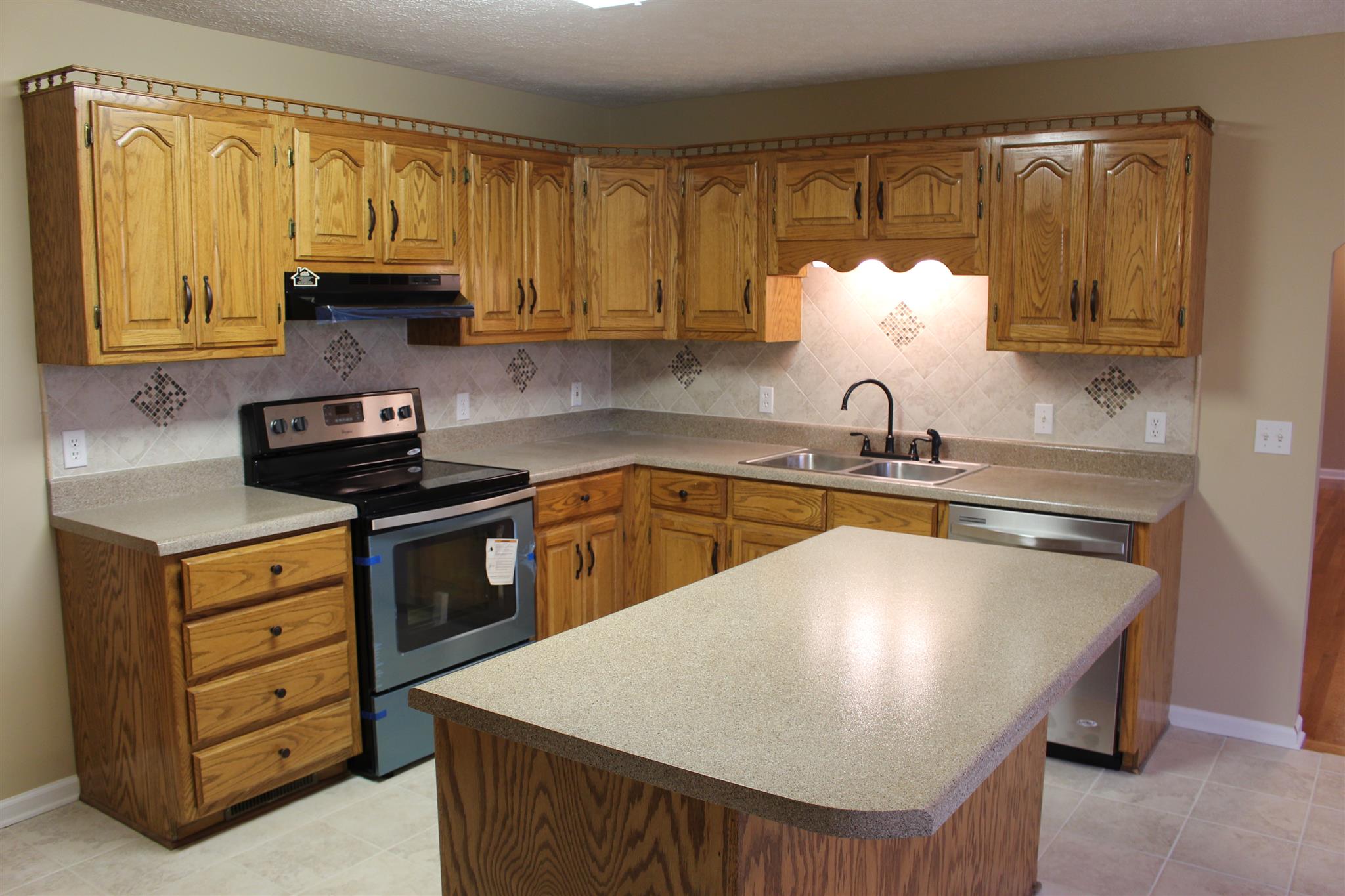 425 Brandon Road Manchester, TN 37355 - Photo 5 of 25 a kitchen with kitchen island granite countertop a sink a stove and cabinets
