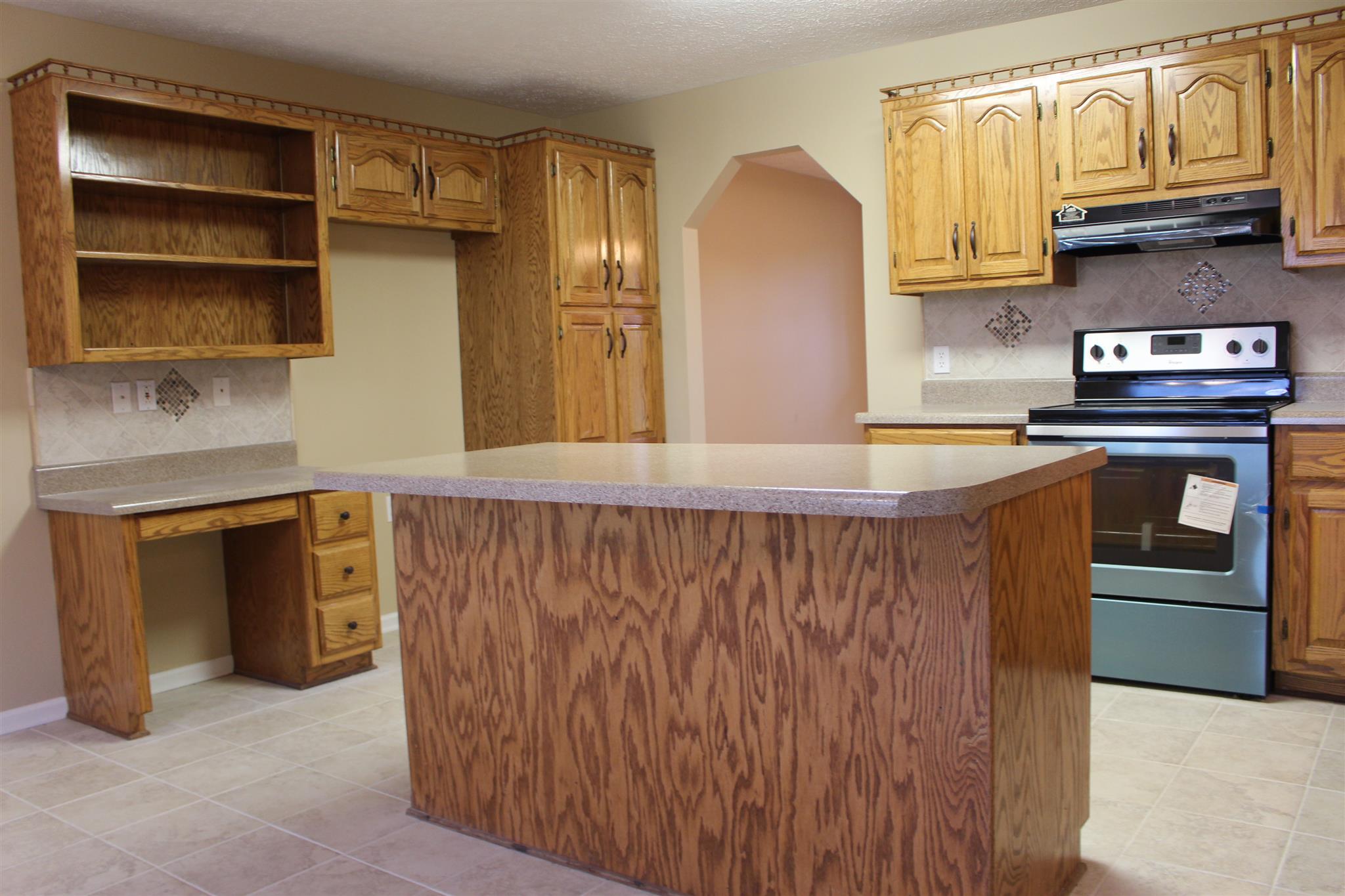 425 Brandon Road Manchester, TN 37355 - Photo 7 of 25 a kitchen with stainless steel appliances granite countertop a refrigerator and a stove top oven