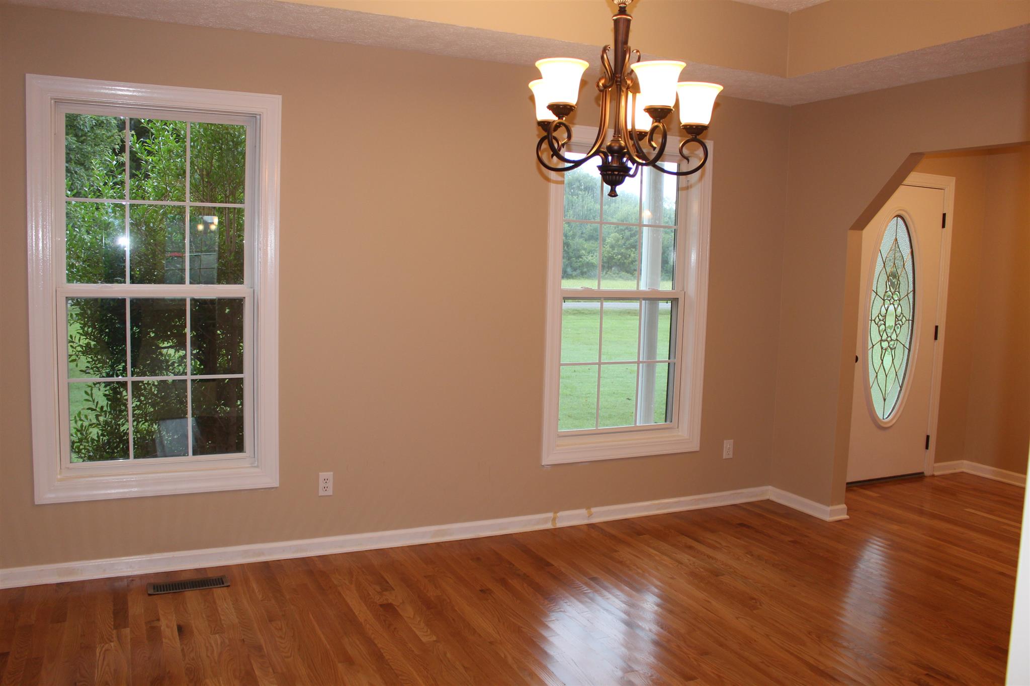 425 Brandon Road Manchester, TN 37355 - Photo 10 of 25 an empty room with wooden floor cabinet and windows