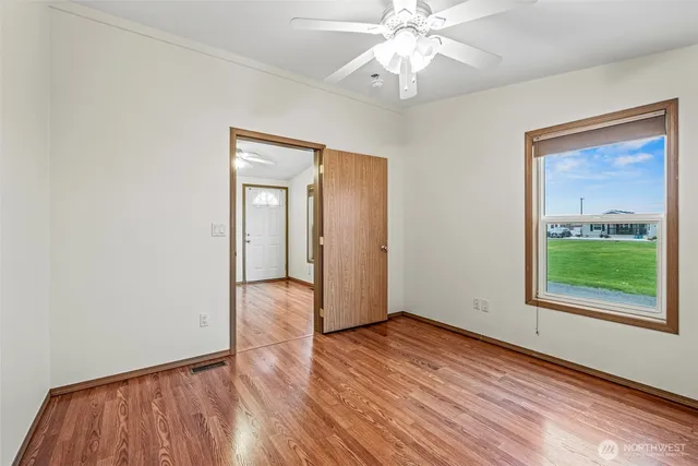 wooden floor in an empty room with a window