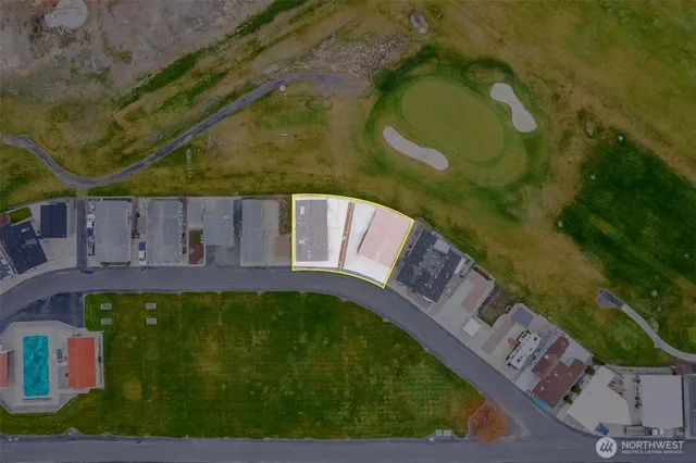 a view of a swimming pool with a yard
