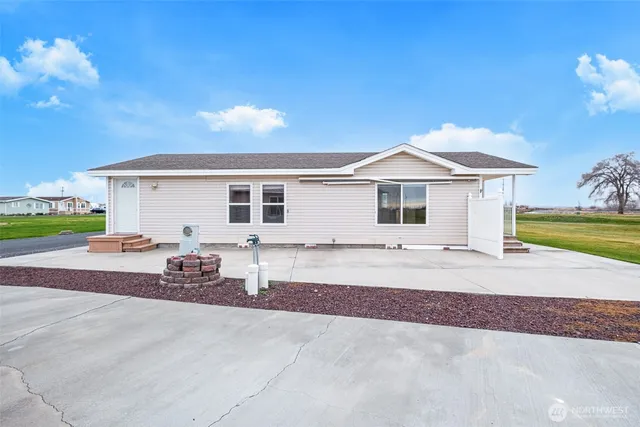 a view of a white house with a yard and a garage