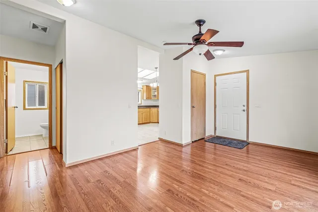 a view of empty room with wooden floor