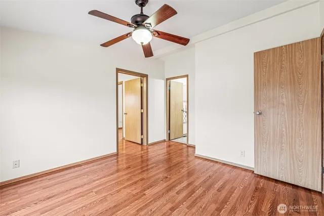 a bathroom with a granite countertop sink a toilet and mirror