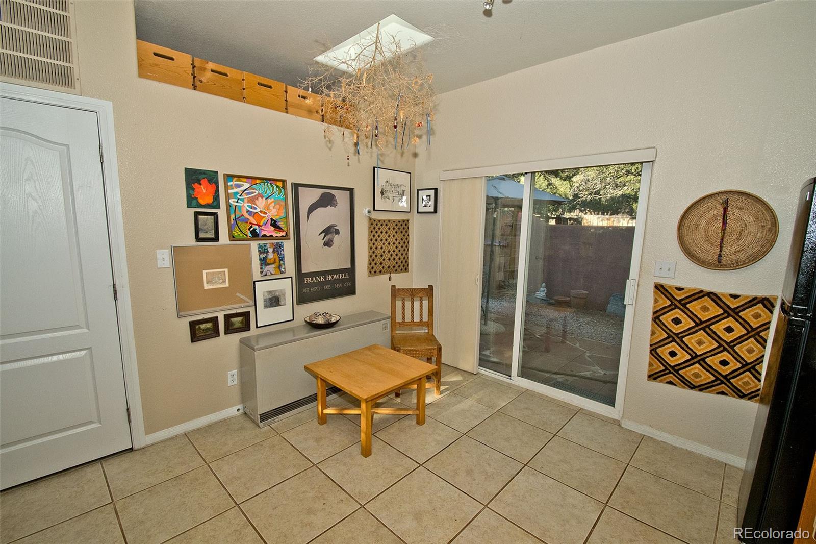 109 Pinewood Overlook Crestone, CO 81131 - Photo 13 of 35 a living room with furniture a piano and a chandelier