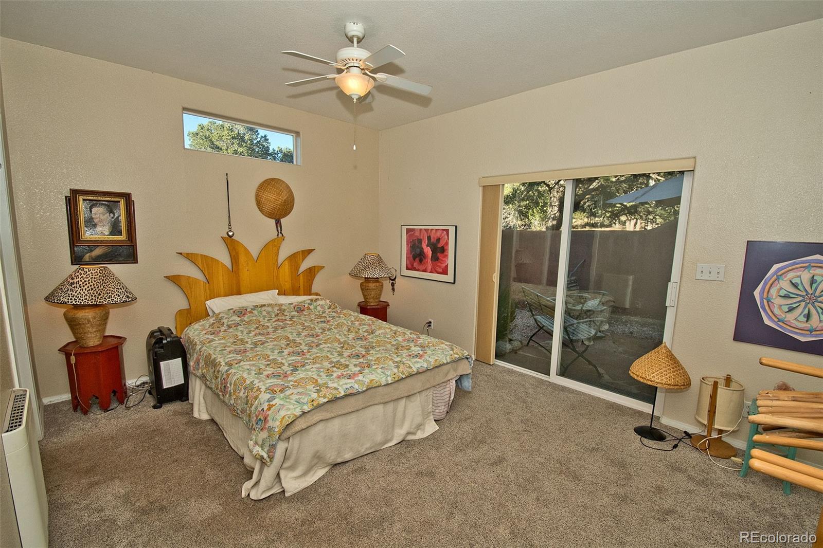 109 Pinewood Overlook Crestone, CO 81131 - Photo 15 of 35 a bedroom with a bed and a chandelier