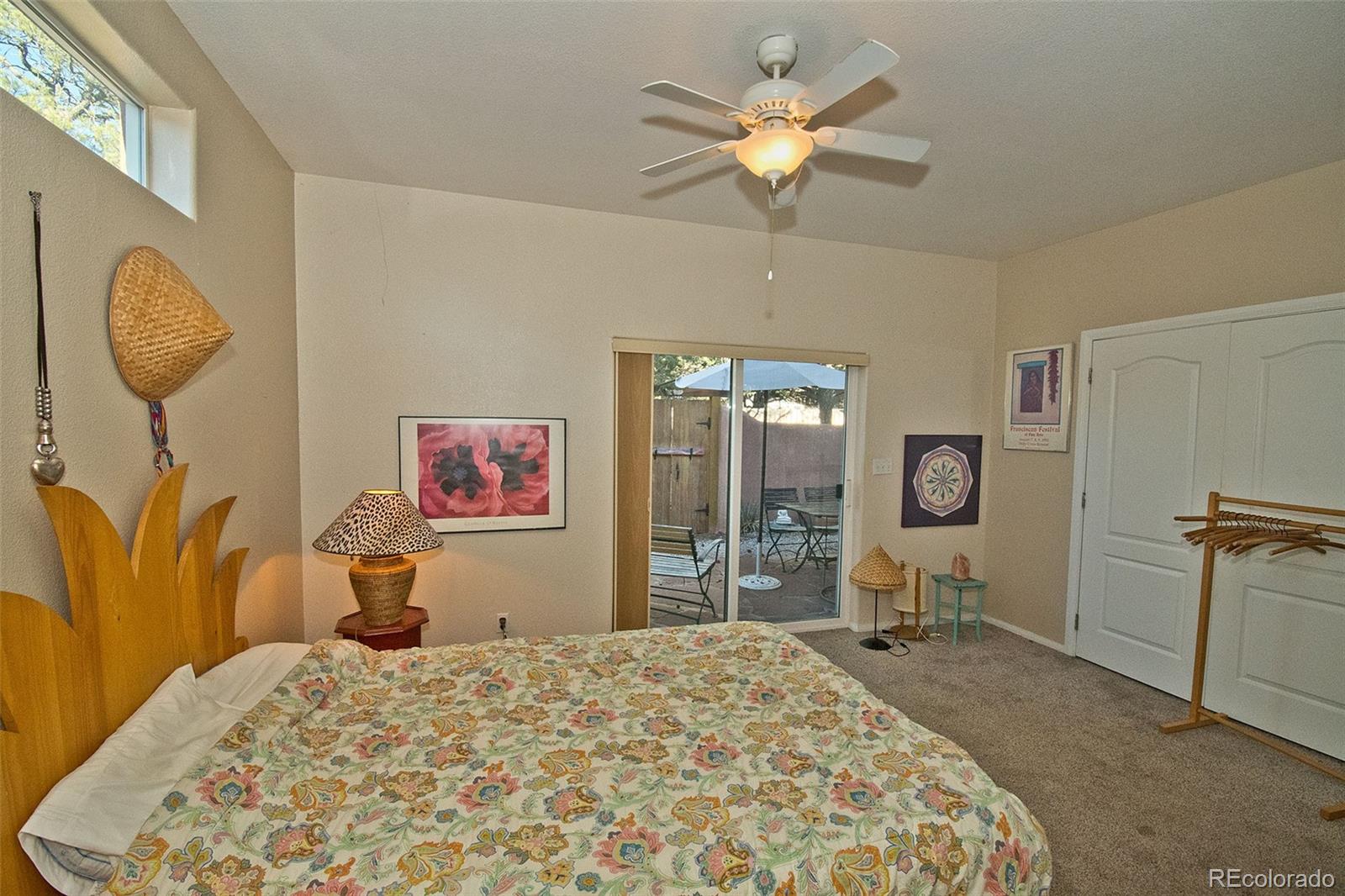 109 Pinewood Overlook Crestone, CO 81131 - Photo 16 of 35 a bedroom with a bed and a chandelier