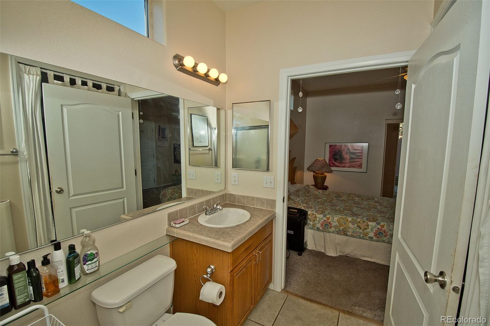 109 Pinewood Overlook Crestone, CO 81131 - Photo 18 of 35 a bathroom with a granite countertop sink mirror vanity and toilet