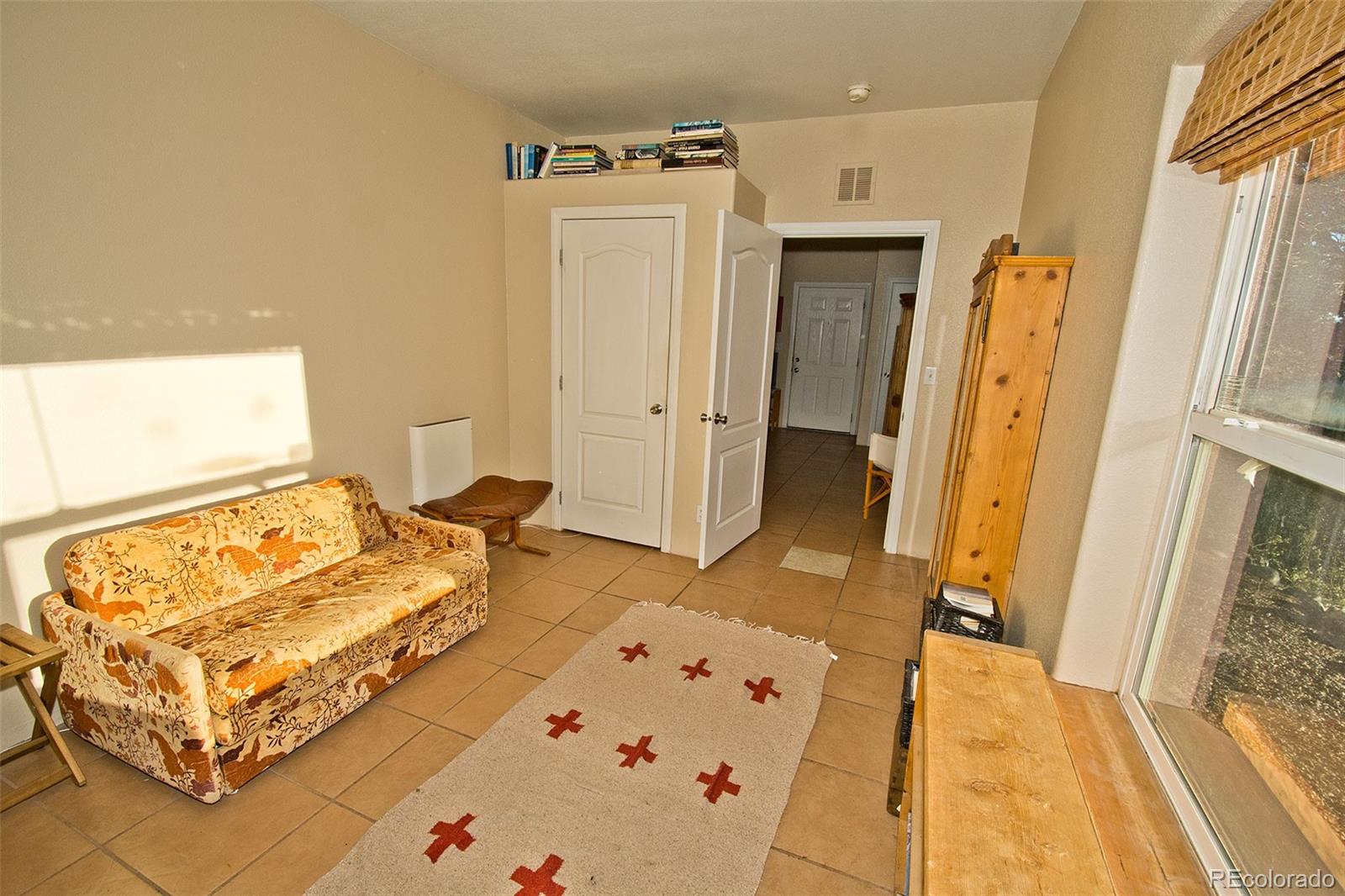 109 Pinewood Overlook Crestone, CO 81131 - Photo 22 of 35 a spacious bedroom with a bed and wooden floor