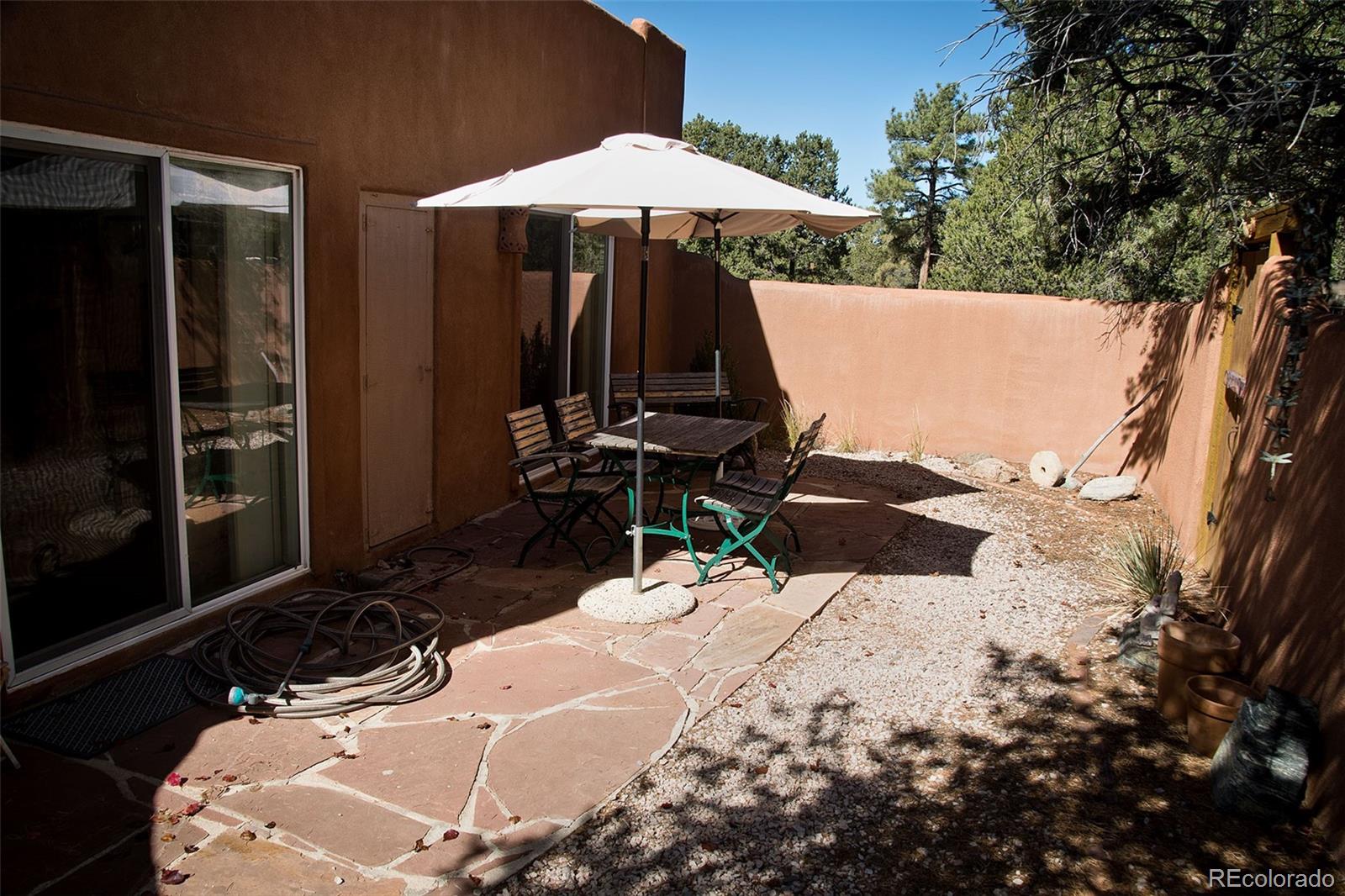 109 Pinewood Overlook Crestone, CO 81131 - Photo 34 of 35 a view of a backyard with table and chairs under an umbrella