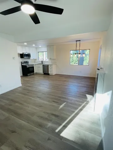 a view of a livingroom with furniture nad wooden floor