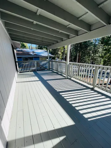 a view of balcony with wooden floor