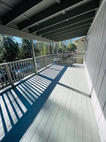 a view of balcony with wooden floor