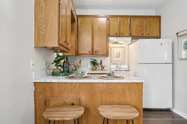 a kitchen with stainless steel appliances granite countertop a sink a stove and a refrigerator