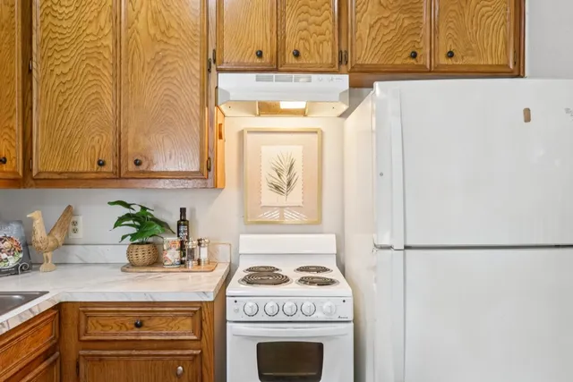 a kitchen with a window a sink and cabinets
