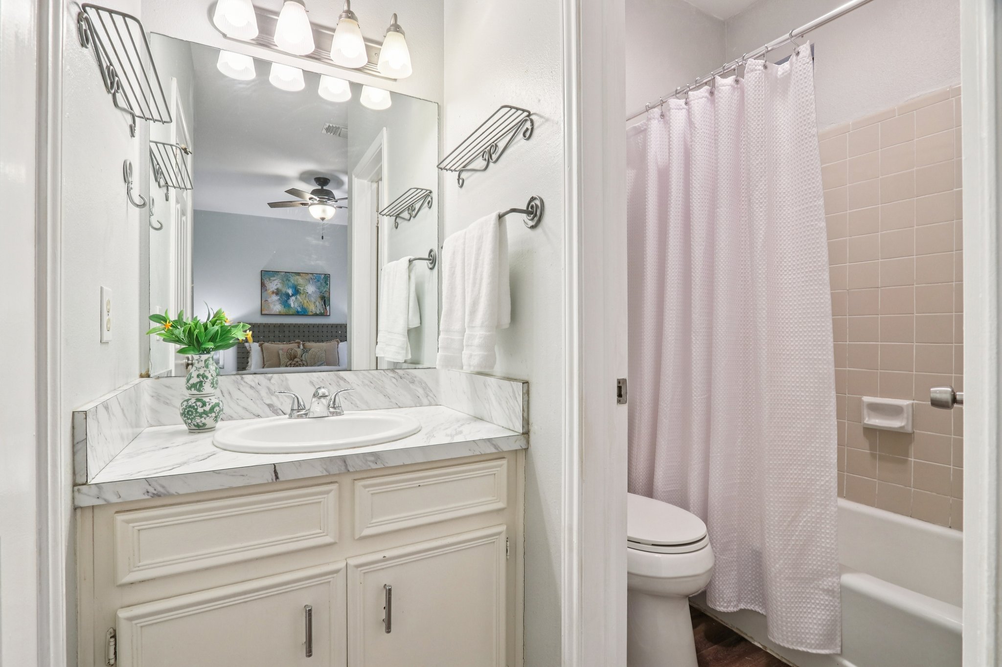 4401 Speedway, Unit 105 Austin, TX 78751 - Photo 26 of 38 a bathroom with a sink a toilet and shower curtain