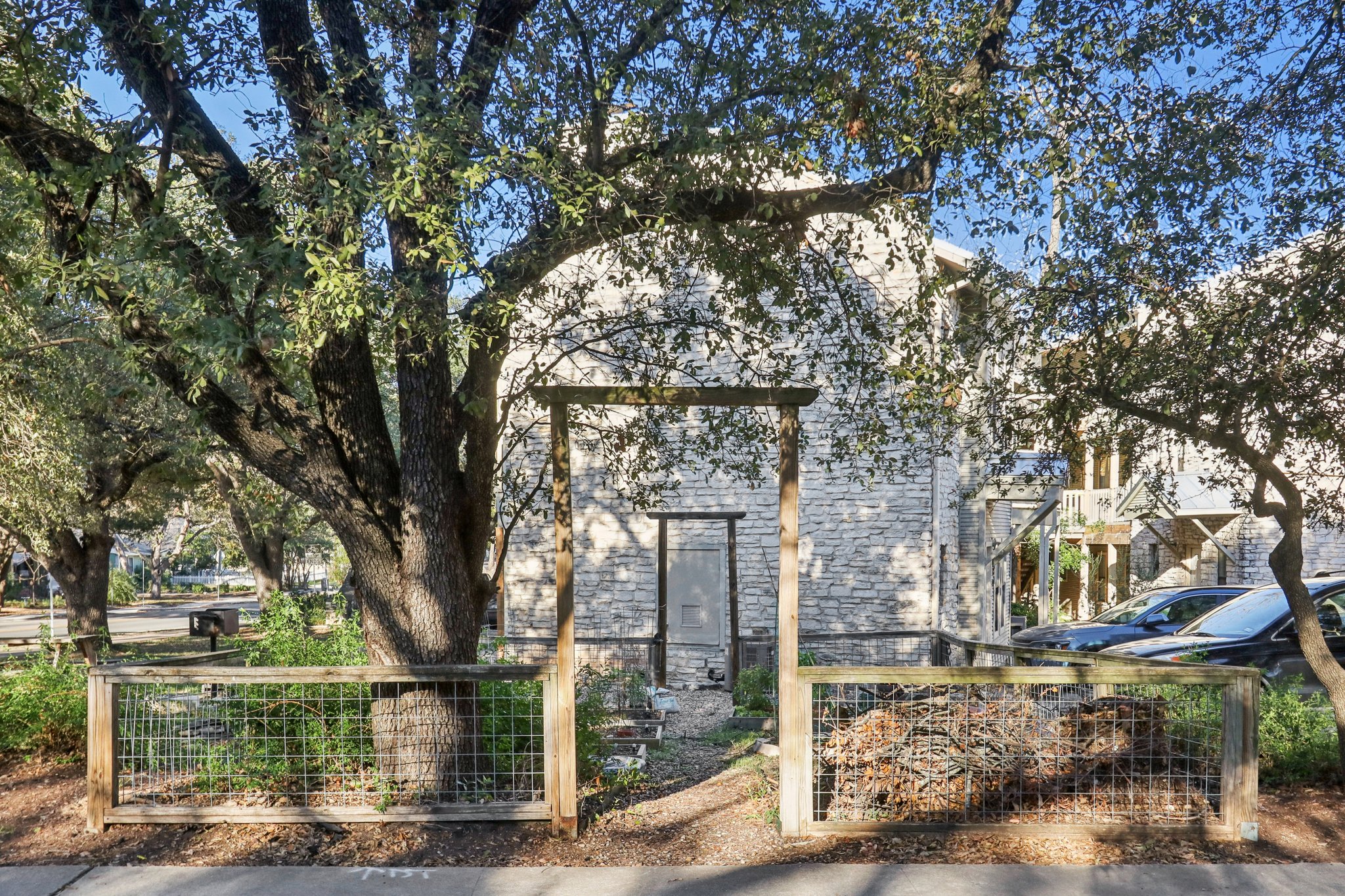 4401 Speedway, Unit 105 Austin, TX 78751 - Photo 7 of 38 a large tree in front of a brick house