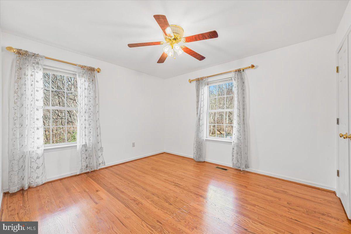 19626 Garretts Mill Road Knoxville, MD 21758 - Photo 14 of 38 a view of an empty room with wooden floor and a window