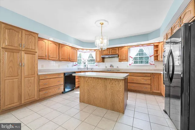 a kitchen with stainless steel appliances granite countertop a sink and dishwasher with white cabinets