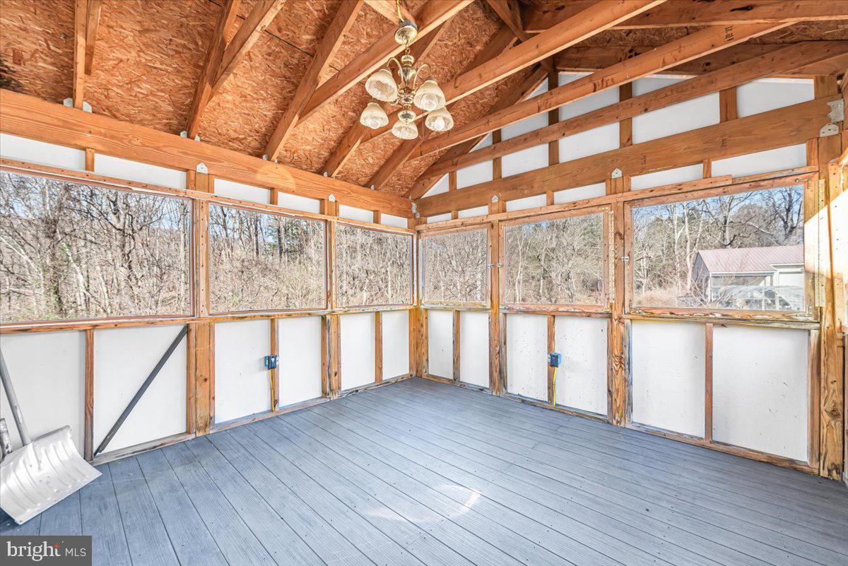 19626 Garretts Mill Road Knoxville, MD 21758 - Photo 26 of 38 a view of an empty room with wooden floor and a window