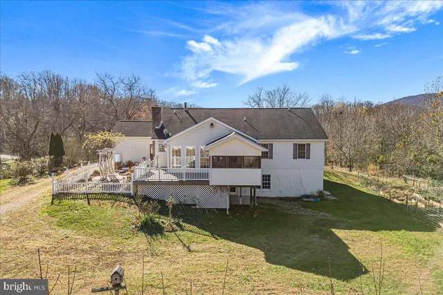 a view of a house with pool and a big yard