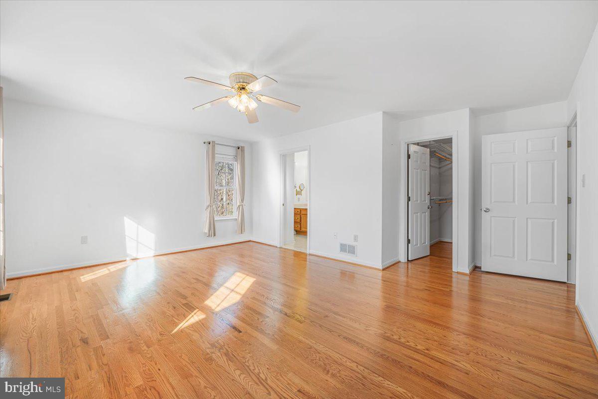 19626 Garretts Mill Road Knoxville, MD 21758 - Photo 5 of 38 a view of an empty room with wooden floor and a ceiling fan