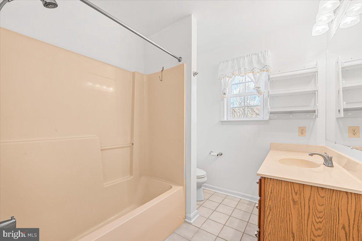 19626 Garretts Mill Road Knoxville, MD 21758 - Photo 10 of 38 a bathroom with a bathtub a window and a shower
