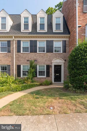 a front view of a brick house with a yard