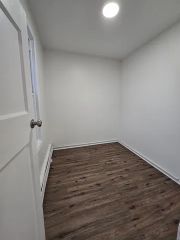 a view of a room with wooden floor