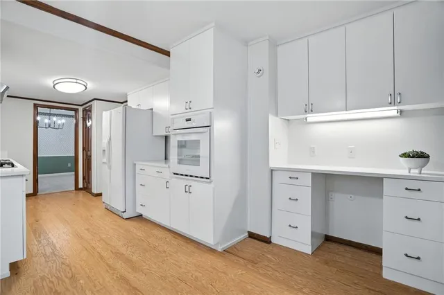 an empty room with chandelier fan