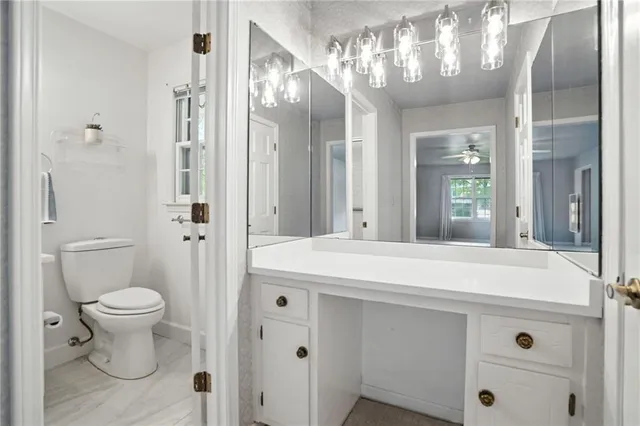 an empty room with chandelier fan