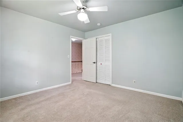 a view of a hallway with wooden floor and entryway