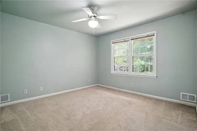 a view of an empty room with wooden walls