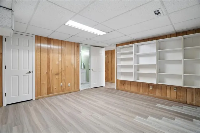 a kitchen with stainless steel appliances kitchen island wooden floors and refrigerator