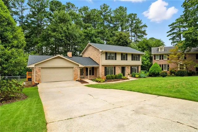 a sign that is sitting on a wooden fence