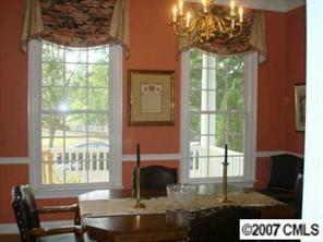 735 Julia Street Fort Mill, SC 29708 - Photo 3 of 8 a living room with a fireplace and a floor to ceiling window