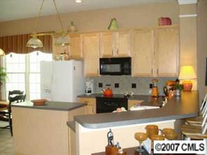 735 Julia Street Fort Mill, SC 29708 - Photo 5 of 8 a kitchen with stainless steel appliances granite countertop a sink and a stove