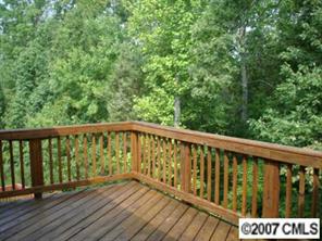 735 Julia Street Fort Mill, SC 29708 - Photo 8 of 8 a deck with tall trees in front of it