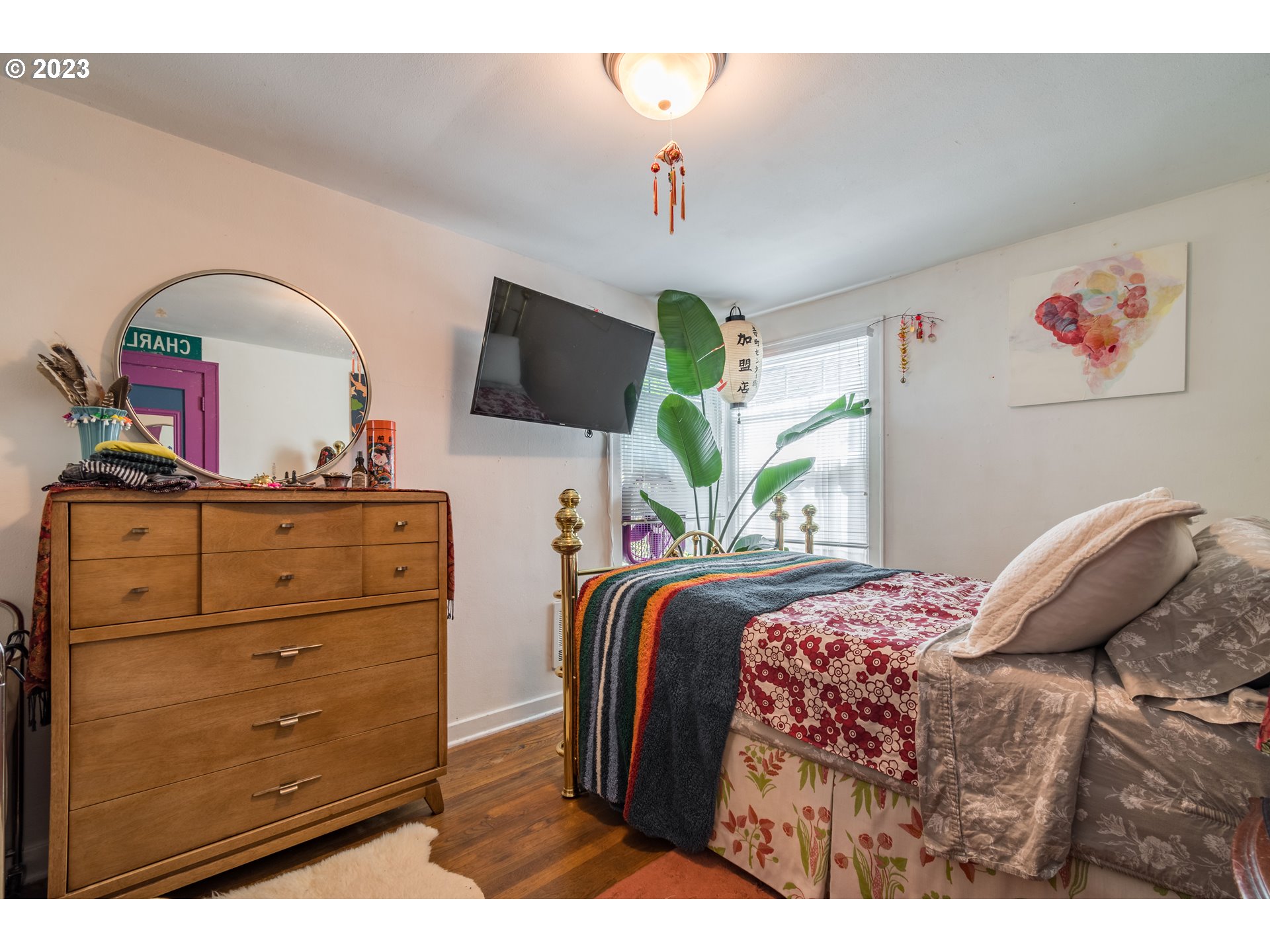 1275 West 5th Avenue Eugene, OR 97402 - Photo 11 of 31 a bedroom with a bed and a flat screen tv