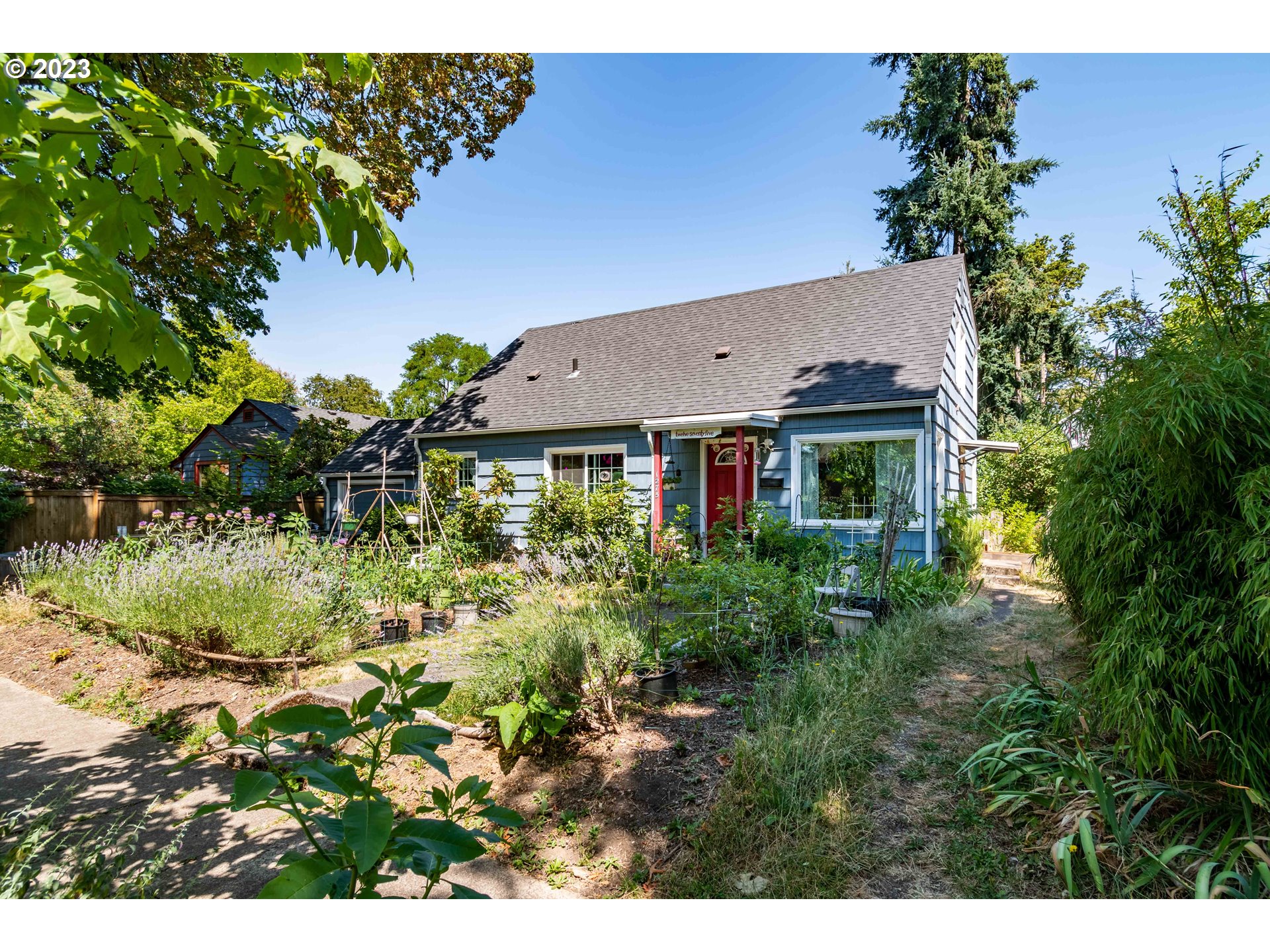 1275 West 5th Avenue Eugene, OR 97402 - Photo 15 of 31 a view of a house with a yard and garden
