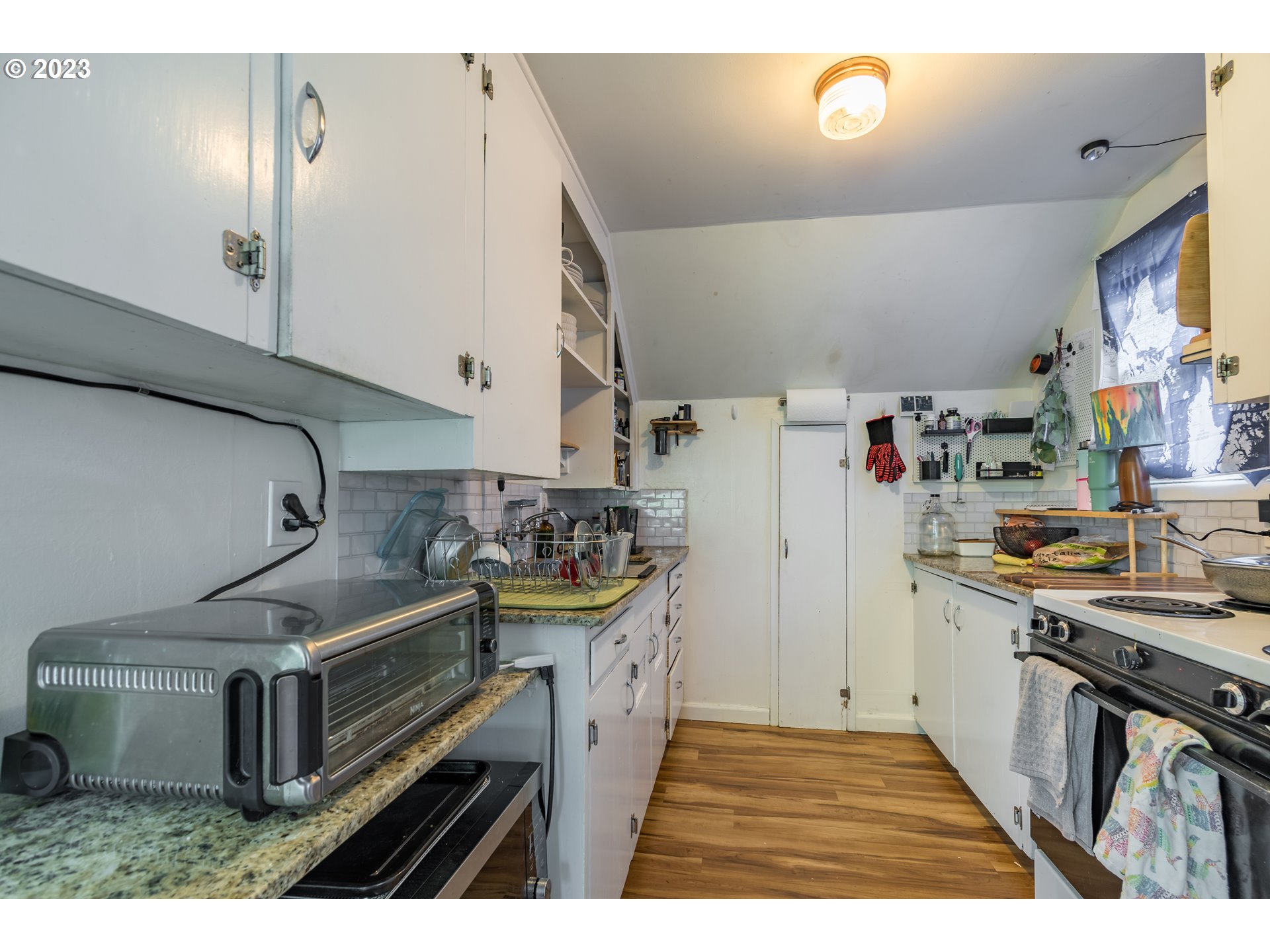 1275 West 5th Avenue Eugene, OR 97402 - Photo 19 of 31 a kitchen that has a lot of cabinets in it