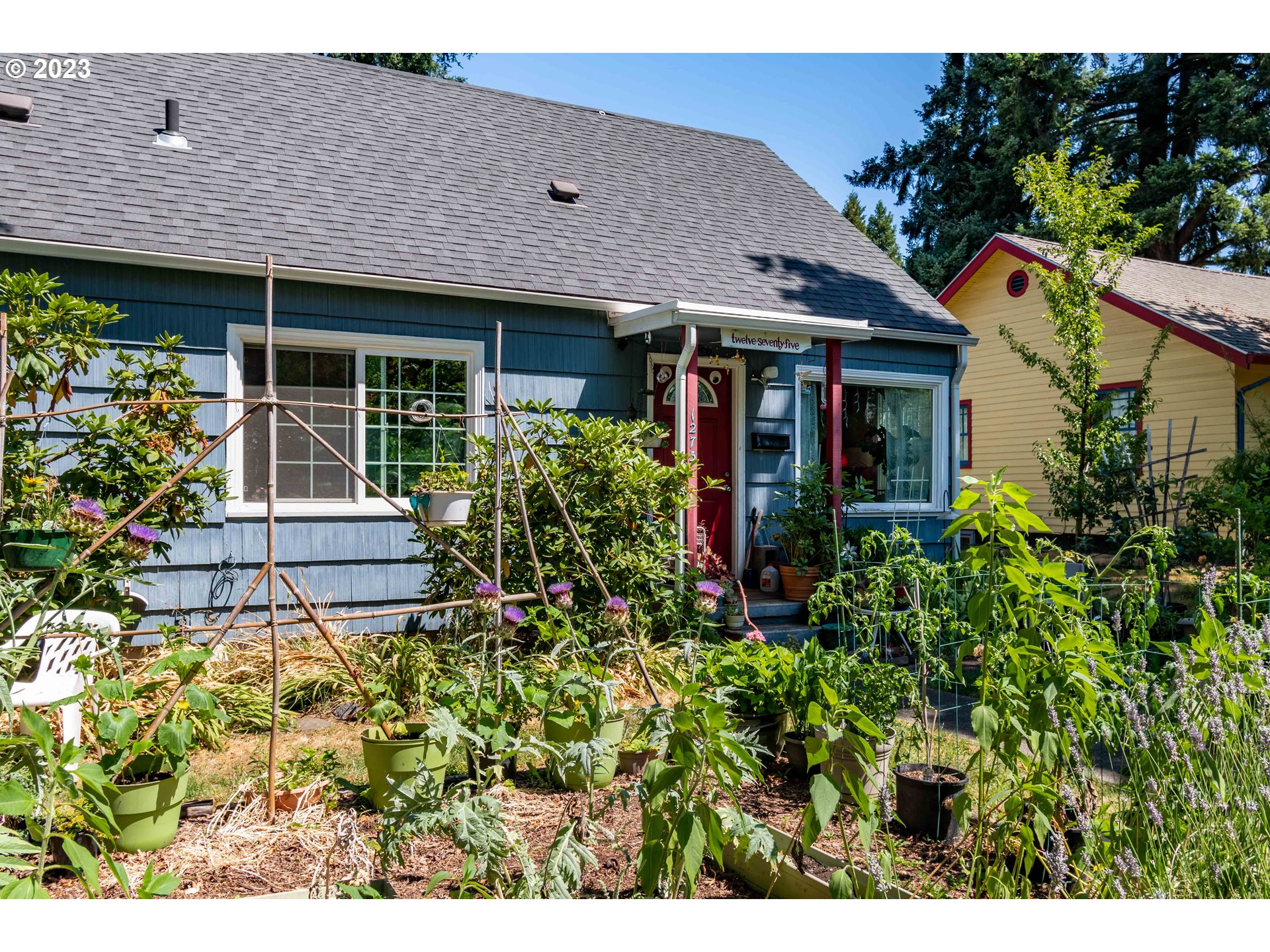 1275 West 5th Avenue Eugene, OR 97402 - Photo 2 of 31 a view of a house with potted plants and a bench