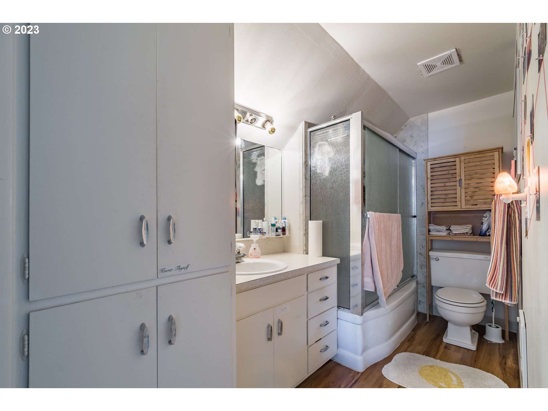 1275 West 5th Avenue Eugene, OR 97402 - Photo 24 of 31 a bathroom with a sink a toilet a mirror and shower